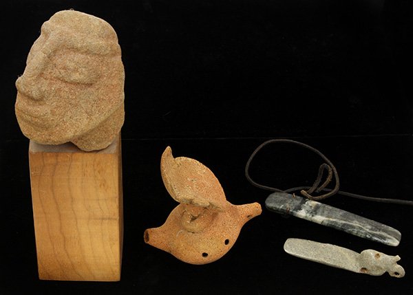 Pre-Columbian objects from Costa Rica: (lot of 4) Pre-Columbian objects from Costa Rica consisting of a clay whistle in the form of a hatted man in boat; volcanic stone head fragment mounted to a wood plinth; and two jade pendants, largest