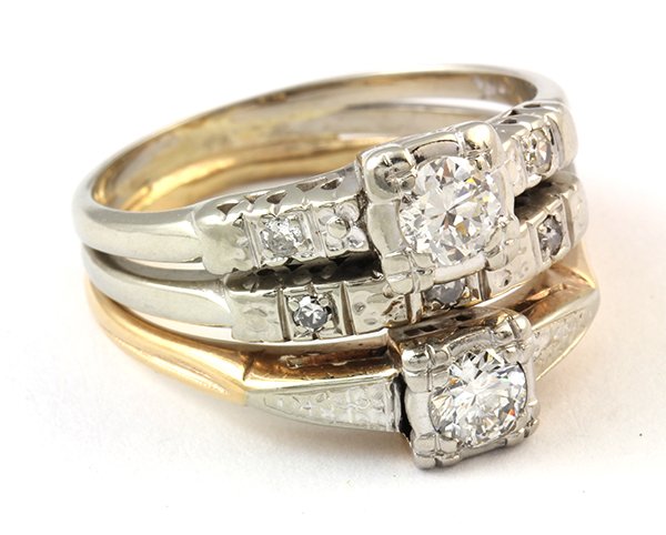 Diamond and 14k gold ring: Diamond and 14k gold ring the three rings soldered together include two engagement rings, one in yellow and one in white gold, with a white gold wedding band in the center. The rings include two old E