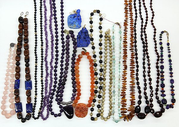 Collection of bead and carved jewelry: Collection of bead and carved jewelry including a carved carnelian bead necklace attached to a large carved carnelian and 14k yellow gold clasp; a sugilite, gemstone and 14k yellow gold bead necklace;