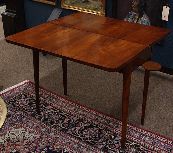 Continental games table: Continental games table, having a hinged rectangular top opening to the later playing surface, surmounting the slide out drink holders, and rising on tapered legs, 30"h x 35"w (open)
