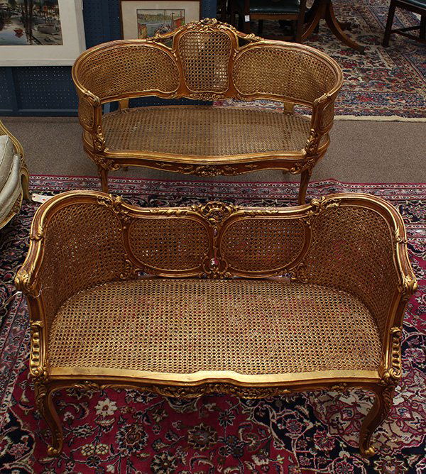 Pair of Louis XV style giltwood carved settees: (lot of 2) Louis XV style giltwood carved settees, each having a contoured back centered with a carved crest surmounting the cane panels, having a shaped seat and rising on cabriole legs, 29.5"h x 41.