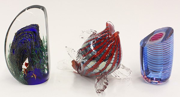 Art glass group: (lot of 3) Art glass group, consisting of a vase having a geometric form, decorated in purple and blue in captured clear glass, signed "Clements 87"; a figural sculpture of a fish executed in a metall
