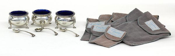 Cartier Georgian style sterling silver open salts with: (lot of 9 plus dust pouches for each piece) Three Cartier Georgian style sterling silver salts with spoons and cobalt glass liners, each open bowl decorated with a band of fine gadrooning, and raised
