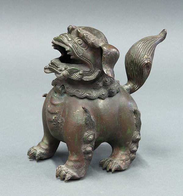 Bronze Fu-lion Censer: Patinated bronze fu-lion censer, with a hinged head form lid with gaping mouth, lobed nose and small eyes, standing with raised bushy tail, 6.75"h. Provenance: From the estate of Edward Gerber