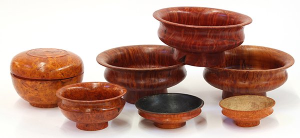 Himalayan Wooden Bowls: (lot of 7) Himalayan burlwood vessels, consisting of four medium sized shallow bowls, two small bowls, and one circular covered box, 6.25"w. Provenance: From the estate of Edward Gerber