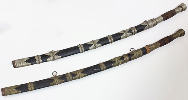 (lot of 2) Burmese decorative swords: (lot of 2) Burmese decorative swords, having etched blades and ebonized wood sheathes mounted with silvered repoussé decorative elements, 35"l