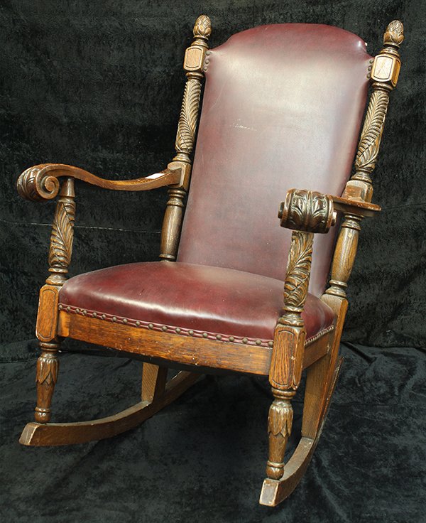 Late Victorian rocking chair: Late Victorian rocking chair, executed in oak circa 1890, having a high back with relief carved stiles, the outswept arms with acanthus carved returns, and rising on turned legs, 40"h x 30"w x 24"d