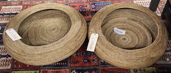 Indonesian coiled storage baskets: (lot of 2) Indonesian coiled storage baskets with lids, possibly from central Lombok, each having a squat low form, larger: 30"dia. Provenance: Property sold to benefit the Phoebe A. Hearst Museum of 