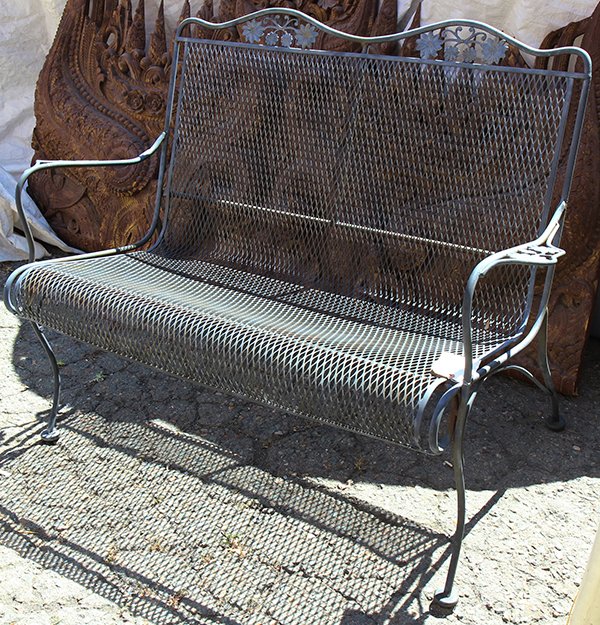 French bistro style iron bench: French bistro style iron bench, the shaped crest decorated with a floral motif, and rising on outswept legs, 34"h x 45"w x 17"d