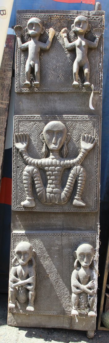 Southeast Asian carved wood door: Southeast Asian carved wood door, the decorative plank having relief carved figures against tribal patterns, 71"h x 19.5"w. Provenance: From the estate of Edward Gerber