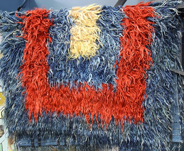Turkish Tulu angora goat carpet: Turkish Tulu angora goat carpet, executed in long goat hair, having concentric rectangles of blue, red and yellow, 6' x 3'11". Provenance: From the estate of Edward Gerber