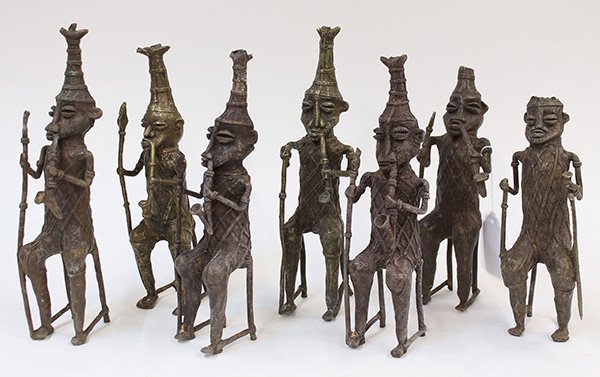 West African decorative brass figures: (lot of 7) West African decorative brass figures depcting seated men smoking pipes, largest: 13.5"h 9. Provenance: From the estate of Edward Gerber