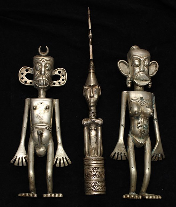Toradya people style, Indonesia: (lot of 3) Toradya people style, Indonesia, decorative metal figures, consisting of a dramatic decorative shamanic type figure of a standing male, and a similar style woman and seated male, largest: 1
