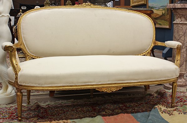 Louis XV style giltwood carved settee: Louis XV style giltwood carved settee, having a carved frame with gadrooning leading to the partially upholstered arms having scrolled returns, continuing to the upholstered seat and back, and rising 