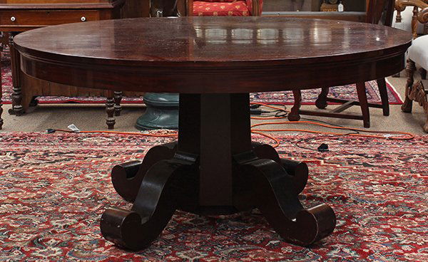 Empire style mahogany dining table: Empire style mahogany dining table, the circular top surmounting the octagonal standard rising on outswept feet, 60"dia. 29.5"h