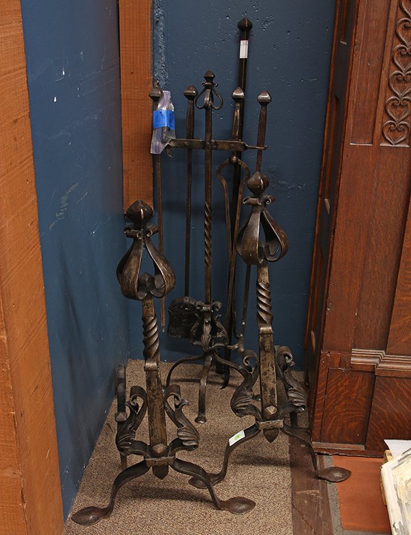 Arts and Crafts wrought iron fireplace accessories: Arts and Crafts wrought iron fireplace accessories, circa 1910, consisting of a pair of andirons and fireplace tool set