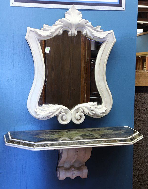 (lot of 2) John Dickinson style mirrored console: (lot of 2) John Dickinson style mirrored console, in two parts, the looking glass of shield form with floral accents, surmounting the console table having chamfered corners and rising on a scroll deco