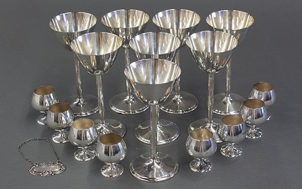 American sterling silver martini's and snifters, 23.18: (lot of 16) American sterling silver barware consisting of eight martini's by International, each stem retaining its silver pouch; and eight miniature sinifters by Gorham; plus a scotch decanter label