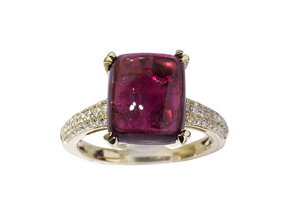 Tourmaline, diamond and 14k yellow gold ring: Tourmaline, diamond and 14k yellow gold ring featuring a buff top raspberry tourmaline weighing approximately 6.84 cts., pave' set half way down the shank with fifty-four full cut diamonds weighing in