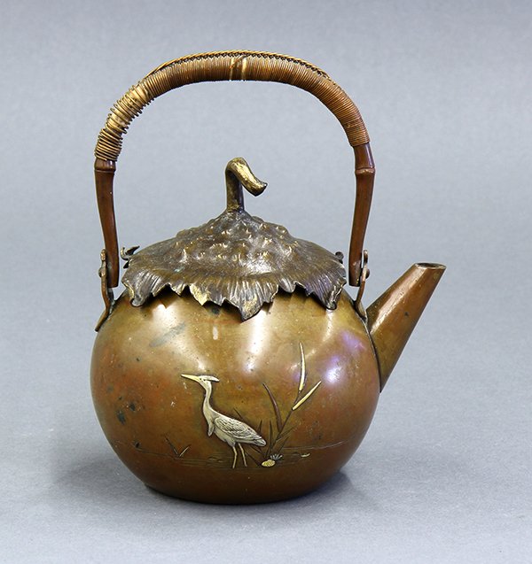 Japanese Copper Teapot, 19c.: Japanese teapot, Meiji period, small rounded body with a handle and an eggplant stem shaped lids, the body with a molded heron on each side by molded/etched pink flowers and reeds in gilt and silver t