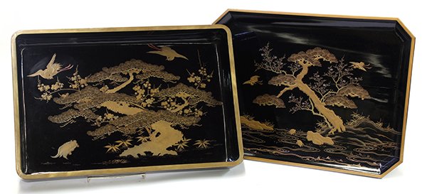 Japanese Lacquered Wooden Trays, 19c: (lot of 2) Japanese black lacquered footed tray table and midarebako (tray for the guest to leave the belongings), Meiji period, pine trees and cranes in gilt takamakie, one with four supports, larges