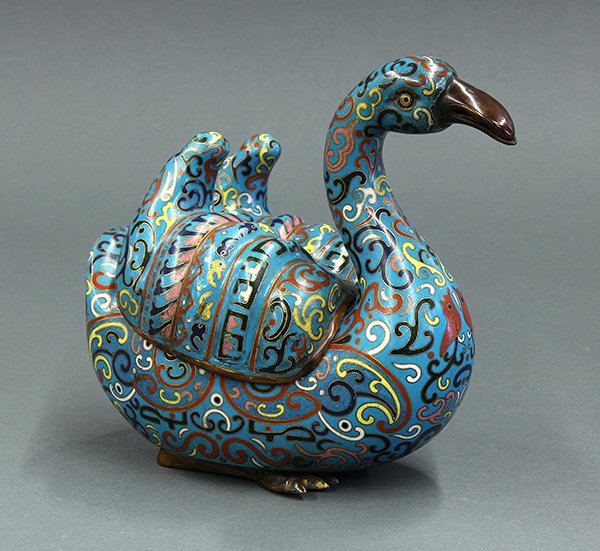Chinese Cloisonne Swan Form Box: Chinese cloisonne enameled swan form box, with a curved neck and wing form lid, the turquoise body with scroll and archaistic pattern in red, blue, white, yellow and pink, 8.75"w