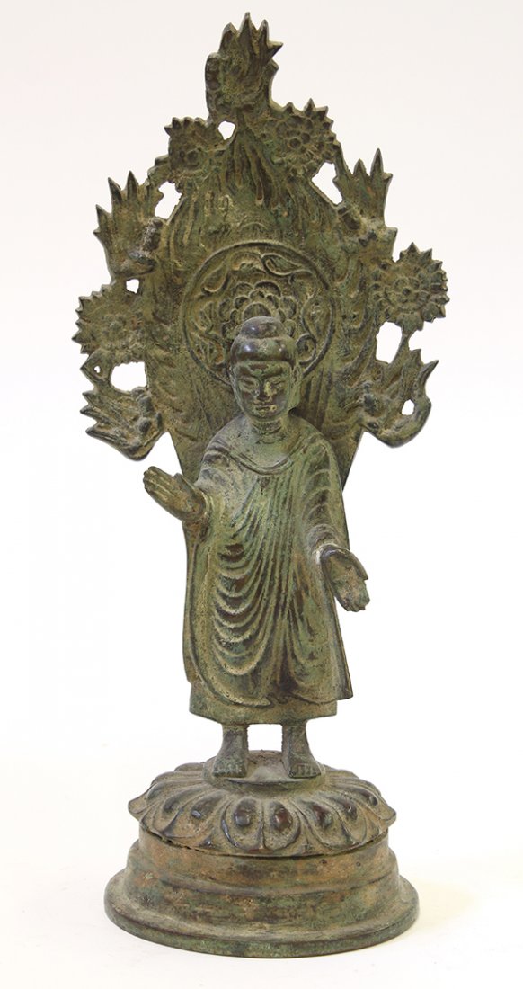 Chinese Northern Wei Style Buddha: Chinese Northern Wei style bronze Buddha, standing with hand in abhaya and varada mudra, backed by a mandorla with a floral medallion accented by apsara, the back with an inscription, 11"h. Provenance