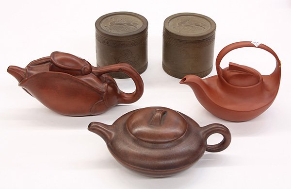 Chinese Yixing/Zisha Teapots/Jars: (lot of 5) Chinese zisha ceramic items, with three teapots of various forms and seals 'Zhang Juying', 'Wang Yinxian' and 'Zhang Shouzhi' to the bottom; pair of cylindrical jars with qilin to the lid a