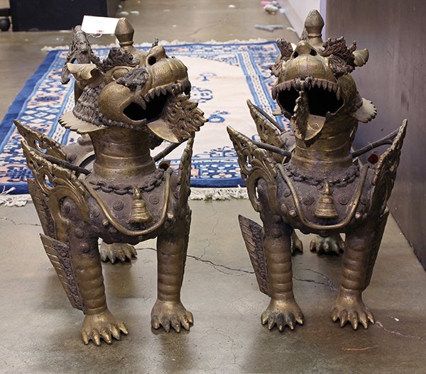 Southeast Asian Copper Alloy Lions: Pair of Southeast Asian copper alloy lions, each of the winged mythical beasts standing on all fours with flame coming out of its jaw, 20.5"w. Provenance: From the estate of Edward Gerber