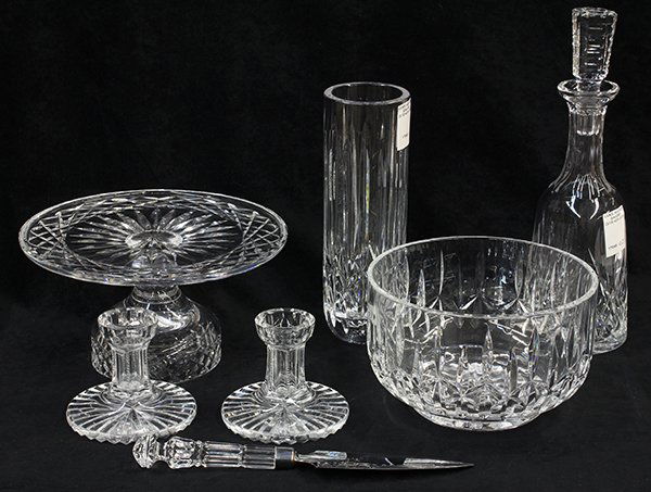 (lot of 7) Waterford crystal table accessories: (lot of 7) Waterford crystal table accessories consisting of a cake stand, a pie server, a decanter, a pair of candlesticks, a serving bowl, and a cylindrical vase, tallest: 10"h