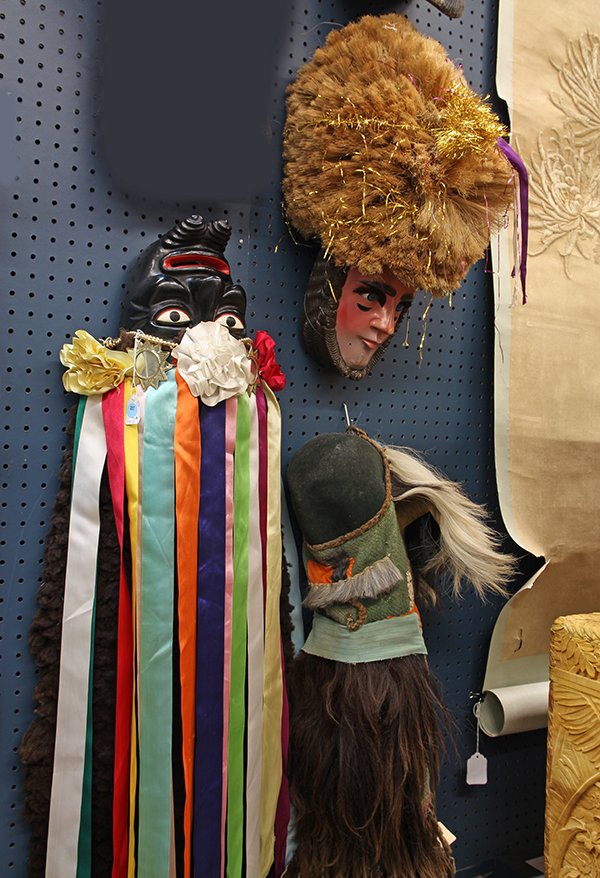 (lot of 3) Mexican mask group, including one in: (lot of 3) Mexican mask group, including one in ebonized wood with polychrome streamers, a Peruvian hunting mask of fabric and long hair and an elaborate wood and fiber mask of a human face with a lar