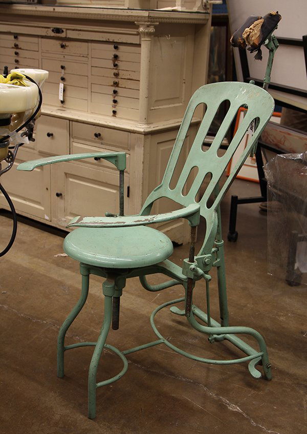 Vintage dental chair, executed in green painted metal,: Vintage dental chair, executed in green painted metal, having a head rest, above a hinged reclining back with a foot pump, continuing to a circular seat, 44"h x 20.5"w x 24"d. Provenance: Deaccessione