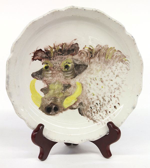 Painted plate, David James Gilhooly: David James Gilhooly (American, b. 1943), Portrait of a Warthog, 1972, oil on English "Erica" dining plate, signed and dated verso, diameter: 9". Provenance: From the estate of Edward Gerber