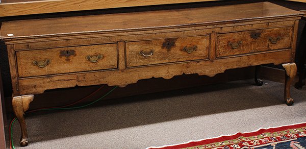 Georgian sideboard executed in quartersawn oak: Georgian sideboard executed in quartersawn oak, 18th century, the rectangular top above three drawers, surmounting the shaped apron, and rising on cabriole legs terminating on claw and ball feet, 30"h