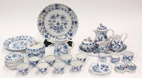 Meissen Blue Onion table service: (lot of 33) Meissen Blue Onion table service, consisting of two tea pots, two creamers, four finger bowls, nine tea cups, a twin salt, two covered dishes, two serving trays, one having a scalloped bor