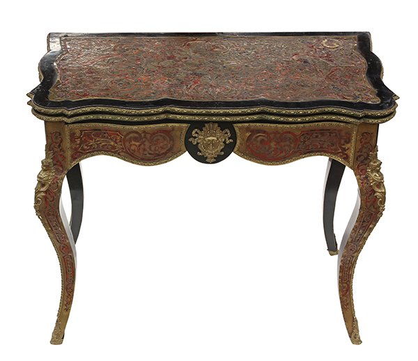 Napoleon III boulle style games table: Napoleon III boulle style games table, circa 1870, the hinged serpentine top having scrolling and foliate detail, opening to reveal a later embossed leather playing surface, the lower case with confor