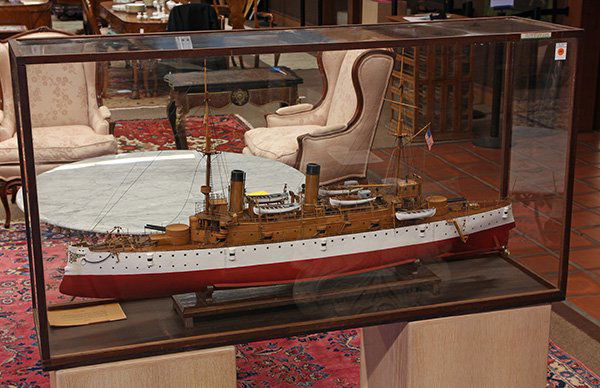 Cased scale model of USS Olympia (C-6): Cased scale model of USS Olympia (C-6) built by Peter P. Peterson in 1925, this model is built on a scale of six feet to one inch, the actual vessel is 72 times the size of this example, The Olympia w