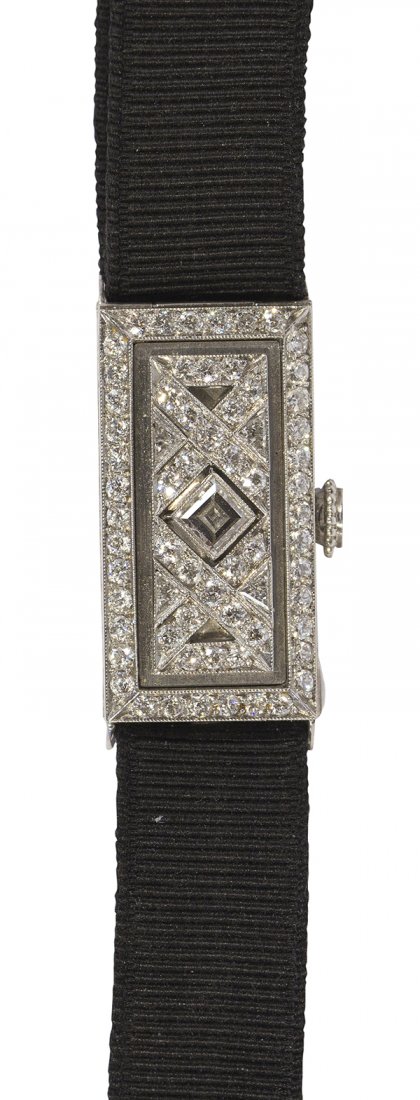 Lady's Art Deco Tiffany & Co. diamond and platinum: Lady's Art Deco Tiffany & Co. diamond and platinum covered wristwatch Case: rectangular platinum, 26 x 13.5 mm, hinged cover is decorated by (1) square cut, (4) triangular cut and (62) old European cu