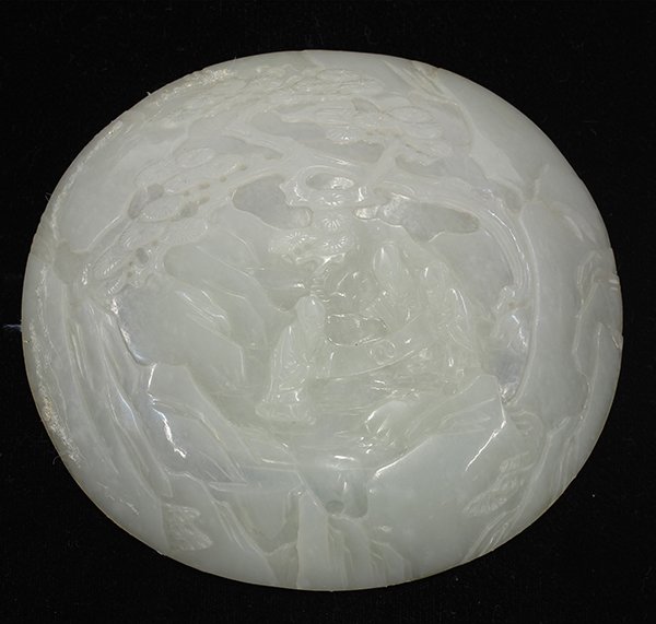 Chinese Nephrite Plaque, Scholars and Scroll: Chinese carved jade oval plaque, Qing dynasty, relief carved with three scholars examining a scroll below a pine tree, with an off-white matrix infused with icy inclusions, 5.25"w