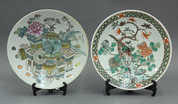 Two Chinese Porcelain Chargers: (lot of 2) Chinese enameled porcelain chargers, one with a pheasant amid flowers and garden rocks in a famille verte palette; the other with the Hundred Antiques pattern, signed Fang Jiazhen, the base