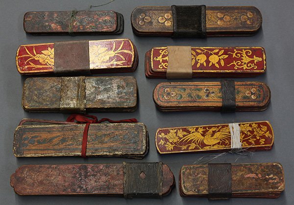 Sets of Tibetan Message Boards: (lot of 10) Sets of Tibetan lacquered message boards, each of the covers painted with flowers or birds, largest: 10.75"w. Provenance: From the estate of Edward Gerber