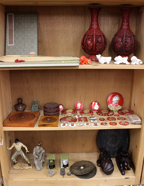 Asian Decoratives: Vases, Mao Buttons, Boxes: Three shelves of Asian decorative items, including two cinnabar style vases; Chairman Mao buttons and plaques; two Chinese compasses, two wooden boxes, two blank albums etc, largest: 17.5"h. Provenanc