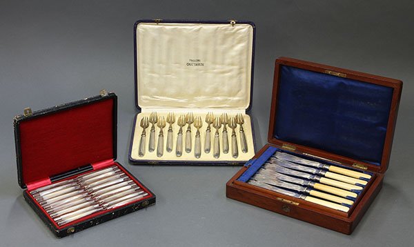 French and English knives and forks: Three boxed sets of cutlery consisting of twelve fish knives by Mappin Brothers, Sheffield, England, 1865-1903, fitted in a carved walnut box mounted with the maker's label and address; together with 