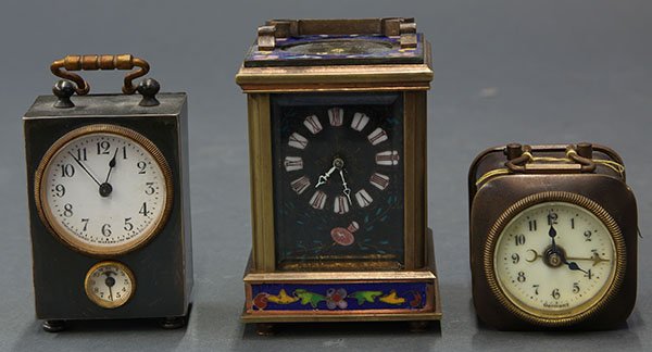 (lot of 3) Two carriage clocks, one by Waterbury Clock: (lot of 3) Two carriage clocks, one by Waterbury Clock Co., the other having a polychrome decorated case depicting angels, housing a Roman numeral dial, together with a German travel alarm clock, larg