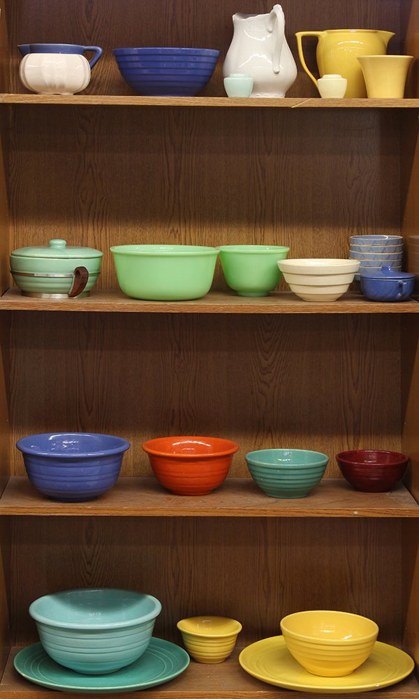 (lot of 25) Four shelves of Mid Century pottery and: (lot of 25) Four shelves of Mid Century pottery and glass, by Bauer, Meyer, and Fireking, including a Bauer covered casserole in seafoam green with its original aluminum and wood base, Bauer ringware 