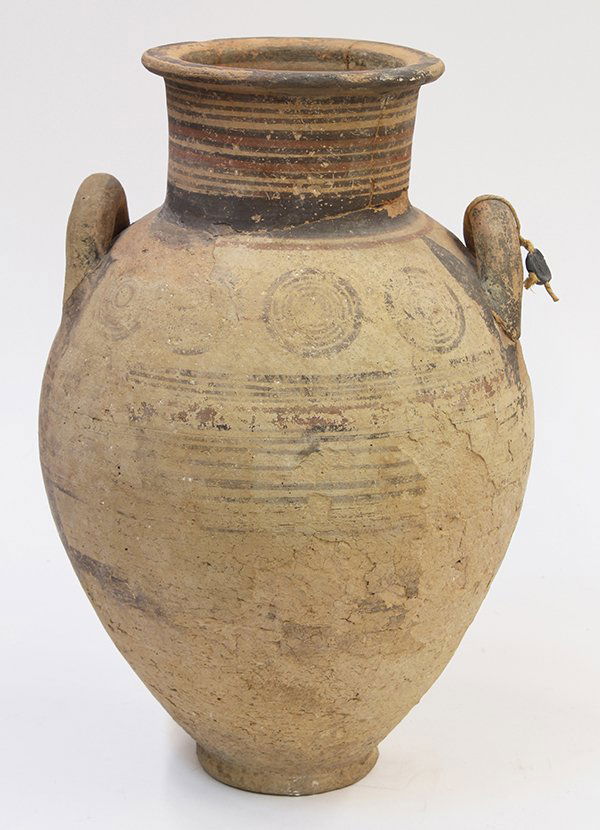 Protogeometric Greek amphora: Protogeometric Greek amphora, circa 1100 BC-900 AD, central Greece, the ovoid form with a short neck and flared rim and having applied handles, the whole decorated with dark red and black circles and