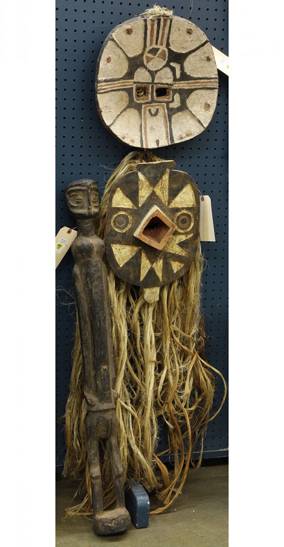 (lot of 3) African carvings consisting of two Teke: (lot of 3) African carvings consisting of two Teke style, Congo masks, one having raffia fiber, and Kwele style, Congo standing figure, 38"l. Provenance: From the estate of Edward Gerber