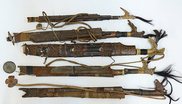 (lot of 5) Dayak swords with scabbards, having carved: (lot of 5) Dayak swords with scabbards, having carved horn handles, four with black hair plumes, three grips are bound with woven rattan thread, the blades have a chiseled edge on one side and are fla