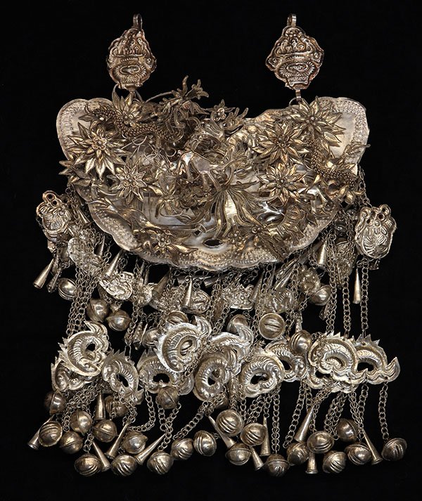 Hill Tribes/Miao (Chinese Minority) silvered pectoral: Hill Tribes/Miao (Chinese Minority) silvered pectoral necklace, the butterfly chest piece having birds and animals, and hung with link chains mounted with dolphin and bell charms. Provenance: From the