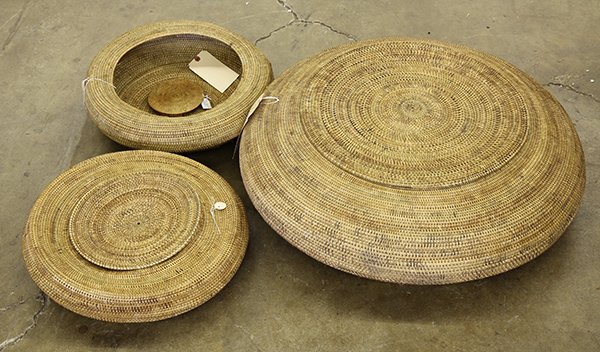 (lot of 3) Indonesian coiled storage baskets with lids,: (lot of 3) Indonesian coiled storage baskets with lids, possibly from central Lombok, of squat round form, largest: 11"h x 29"diam. Provenance: Property sold to benefit the Phoebe A. Hearst Museum of 